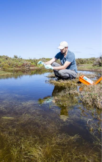 man taking water sample