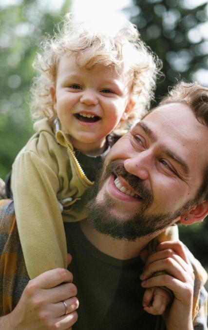 man with child on his back